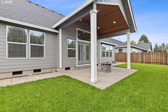 back of house featuring a lawn, a patio area, fence, and french doors