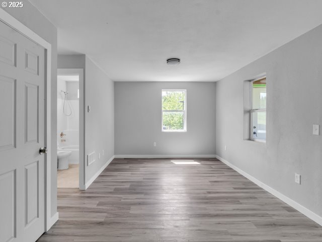 9257 SE Clinton St, Portland, OR 97266 - empty room featuring wood finished floors and baseboards