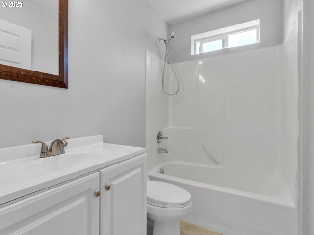 9257 SE Clinton St, Portland, OR 97266 - bathroom featuring vanity, toilet, and bathtub / shower combination