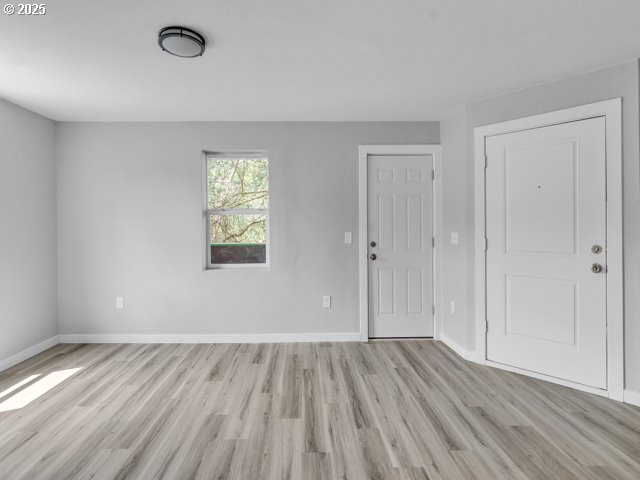 9257 SE Clinton St, Portland, OR 97266 - foyer entrance with light wood-style flooring and baseboards