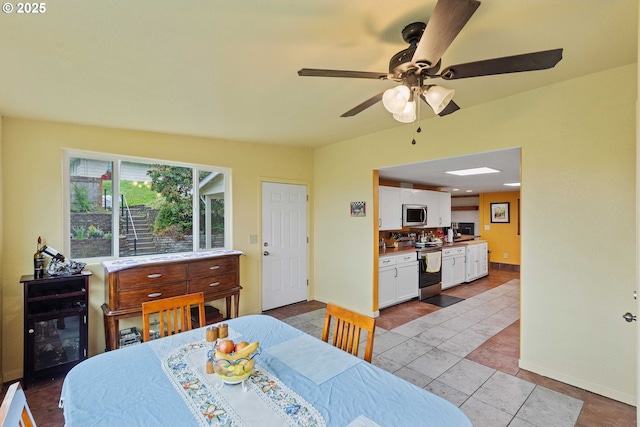 500 State St, North Bend, OR 97459 - dining area with baseboards, ceiling fan, and light tile patterned flooring