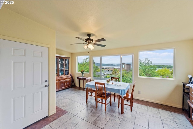 500 State St, North Bend, OR 97459 - dining room with baseboards, ceiling fan, and light tile patterned flooring