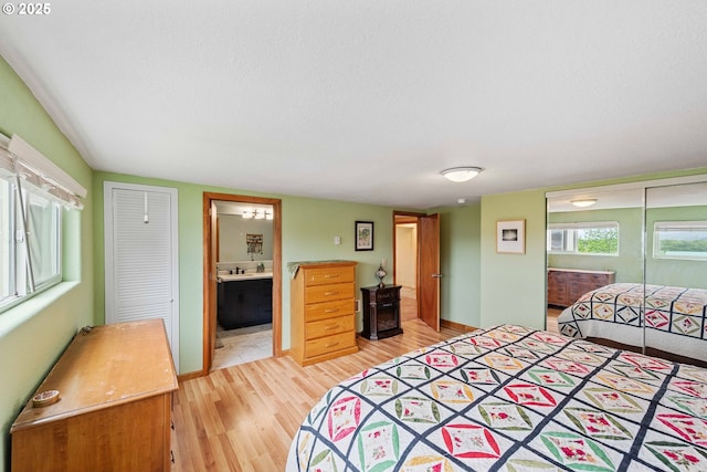 500 State St, North Bend, OR 97459 - bedroom with light wood-style flooring, a closet, and ensuite bath