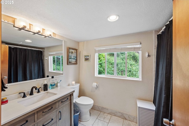 500 State St, North Bend, OR 97459 - full bathroom featuring marble look tile flooring, vanity, toilet, a textured ceiling, and a shower with curtain