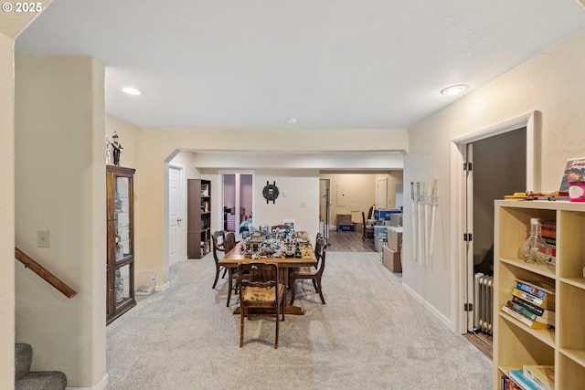 500 State St, North Bend, OR 97459 - carpeted dining space with radiator, stairway, baseboards, recessed lighting, and arched walkways