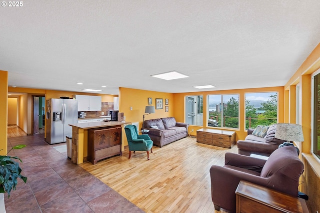 500 State St, North Bend, OR 97459 - living area featuring a textured ceiling and wood finished floors
