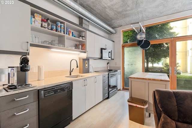 kitchen featuring sink, white cabinets, electric range, and dishwasher