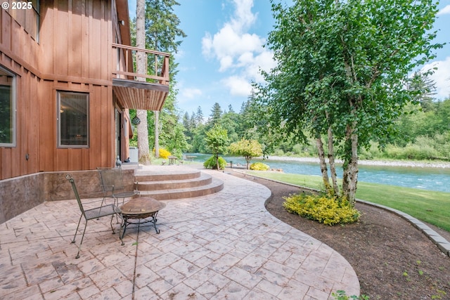 11874 Riverhaven Ln, Stayton, OR 97383 - view of patio / terrace with a water view, a balcony, and a fire pit