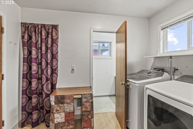 laundry room featuring light wood-style flooring and washing machine and clothes dryer