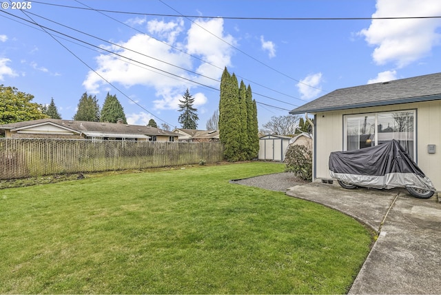 view of yard with a fenced backyard, an outdoor structure, a storage shed, and a patio