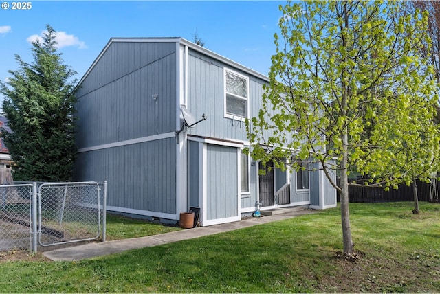 view of side of property with crawl space, a lawn, and fence