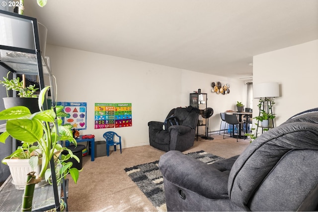 living room featuring carpet and baseboards