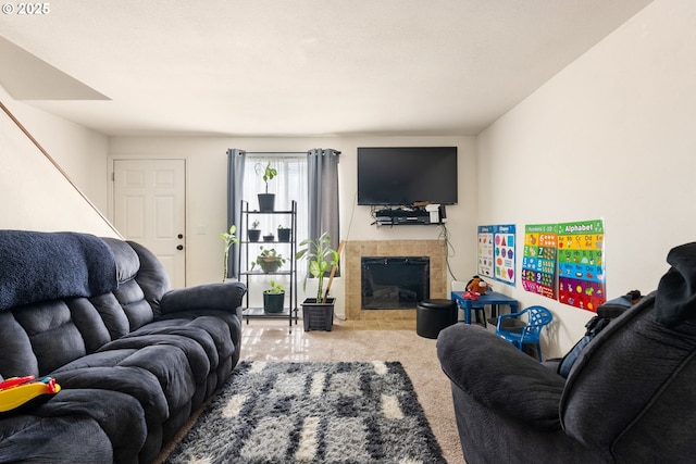 living area with carpet floors and a tile fireplace