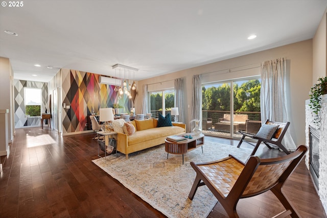 living room with wood-type flooring, baseboards, and recessed lighting