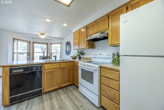 7324 B St, Springfield, OR 97478 - kitchen featuring white appliances, under cabinet range hood, a peninsula, light wood-type flooring, and light countertops
