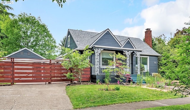912 Van Buren St, Eugene, OR 97402 - view of front facade featuring driveway, a front yard, a chimney, and a shingled roof