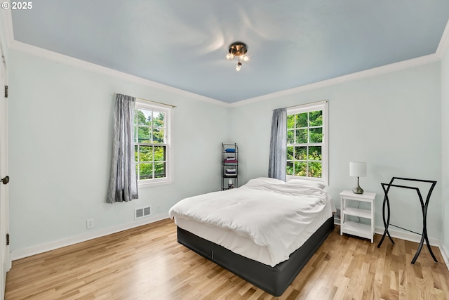 912 Van Buren St, Eugene, OR 97402 - bedroom with crown molding, multiple windows, light wood-style flooring, and baseboards