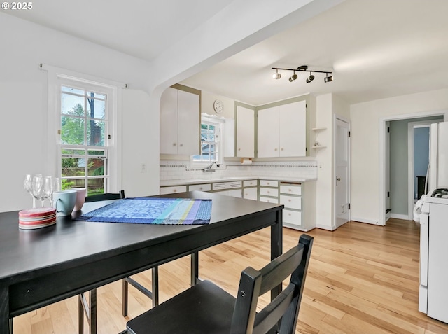 912 Van Buren St, Eugene, OR 97402 - dining room with plenty of natural light, light wood-type flooring, and arched walkways