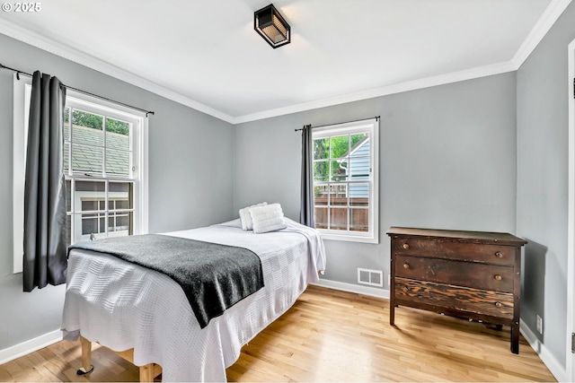 912 Van Buren St, Eugene, OR 97402 - bedroom featuring multiple windows, baseboards, ornamental molding, and light wood-style floors