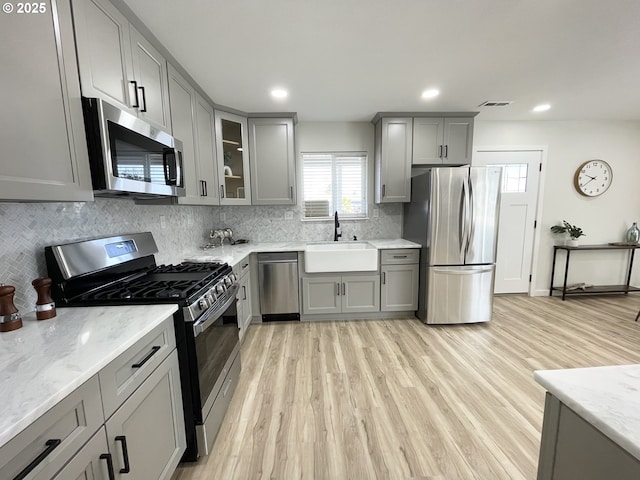 2660 Evergreen Ct, Salem, OR 97301 - kitchen with appliances with stainless steel finishes, gray cabinetry, a sink, light stone countertops, and recessed lighting