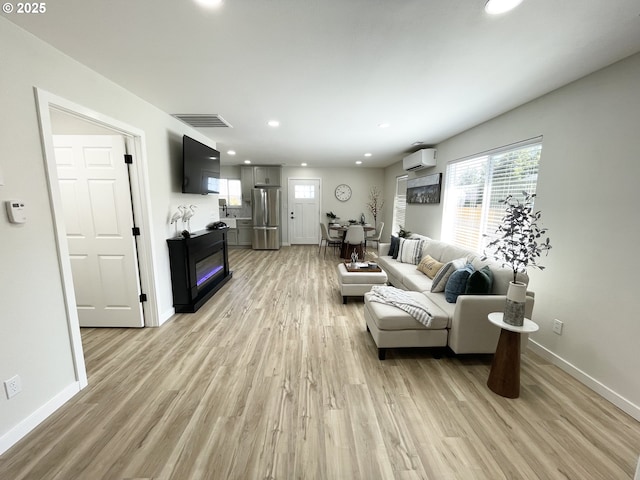 2660 Evergreen Ct, Salem, OR 97301 - living area with a wall mounted air conditioner, light wood finished floors, recessed lighting, and baseboards