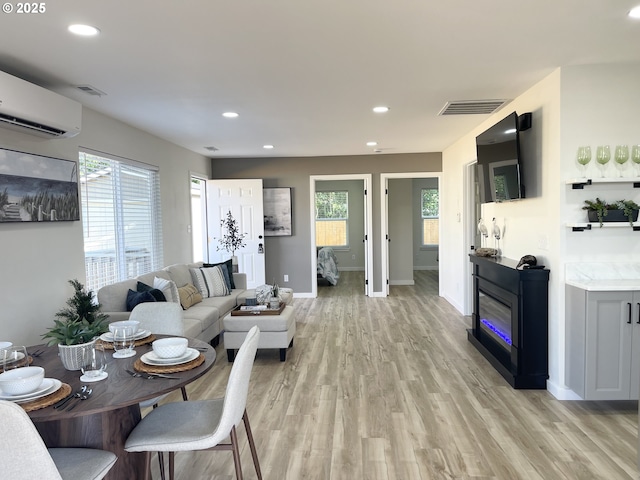 2660 Evergreen Ct, Salem, OR 97301 - living room with a wall unit AC, recessed lighting, light wood-type flooring, and baseboards