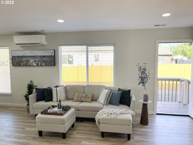 2660 Evergreen Ct, Salem, OR 97301 - living room featuring an AC wall unit, wood finished floors, baseboards, and recessed lighting