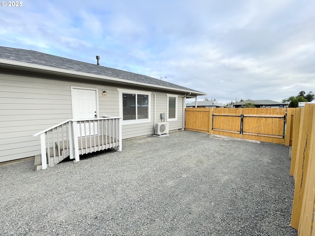 2660 Evergreen Ct, Salem, OR 97301 - back of property with ac unit, a shingled roof, and a gate