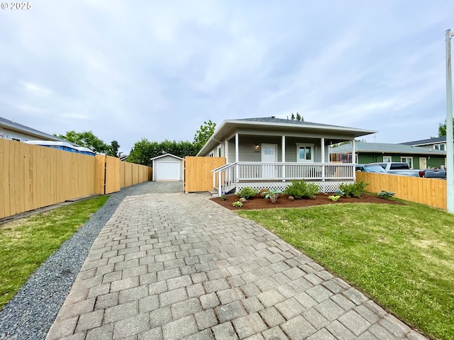 2660 Evergreen Ct, Salem, OR 97301 - view of front facade with a porch, decorative driveway, an outbuilding, and a garage
