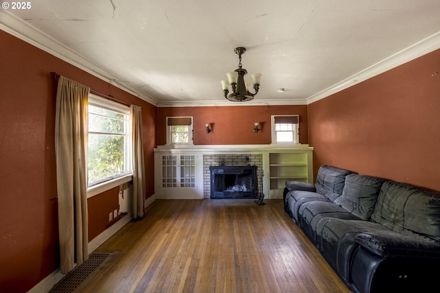 3955 SE Kelly St, Portland, OR 97202 - living area with wood-type flooring, a chandelier, a fireplace, and crown molding