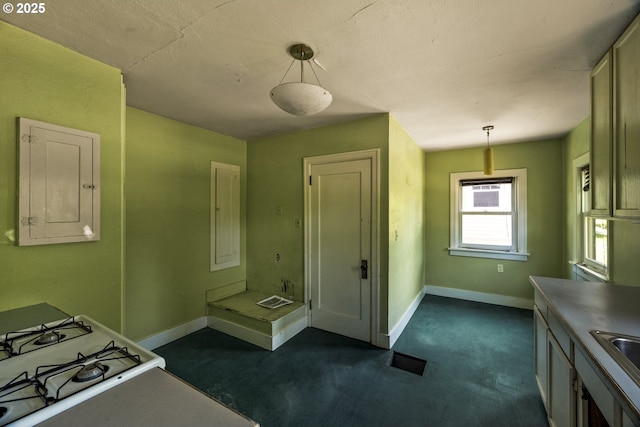 3955 SE Kelly St, Portland, OR 97202 - kitchen featuring hanging light fixtures, electric panel, gas range gas stove, and dark colored carpet