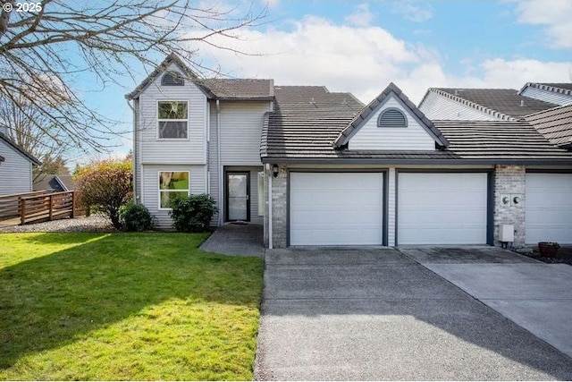 view of front of house with a garage, fence, concrete driveway, and a front yard