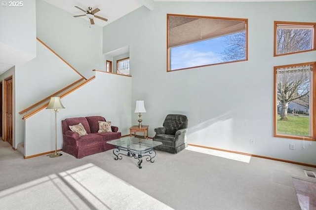 living area featuring high vaulted ceiling, carpet, and beam ceiling