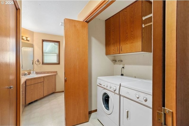 laundry area featuring a sink, light floors, cabinet space, and independent washer and dryer