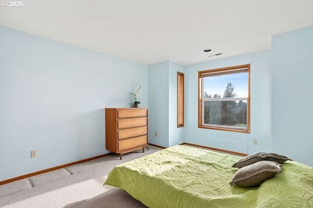 bedroom featuring baseboards and light colored carpet