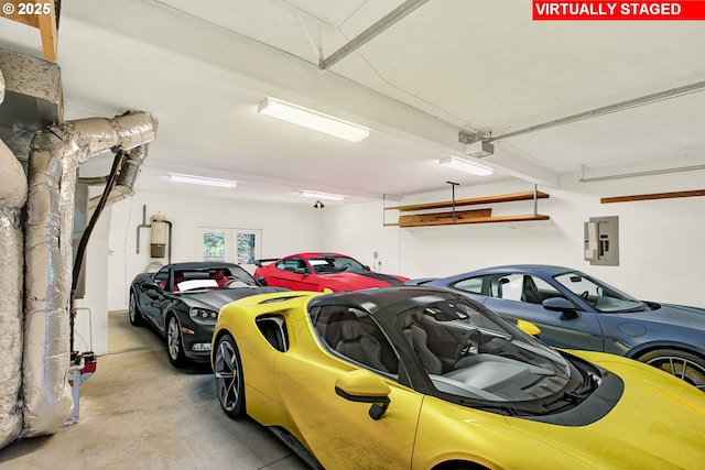 garage with electric panel and a garage door opener