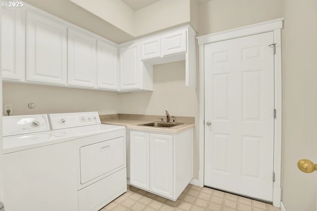 clothes washing area with washer and clothes dryer, light floors, cabinet space, and baseboards