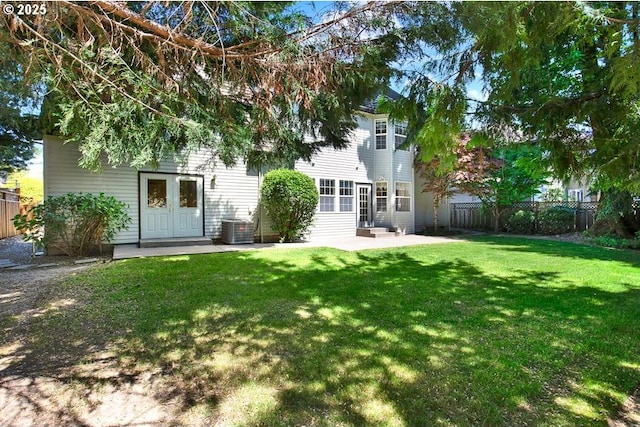 back of house featuring a patio area, central AC, and french doors