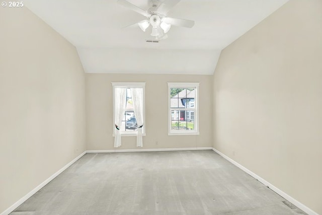 unfurnished room featuring lofted ceiling, a ceiling fan, light colored carpet, and baseboards