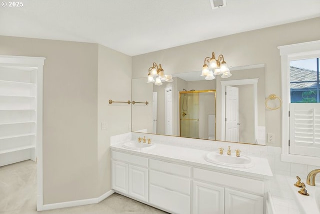 bathroom featuring a stall shower, double vanity, a chandelier, and a spacious closet