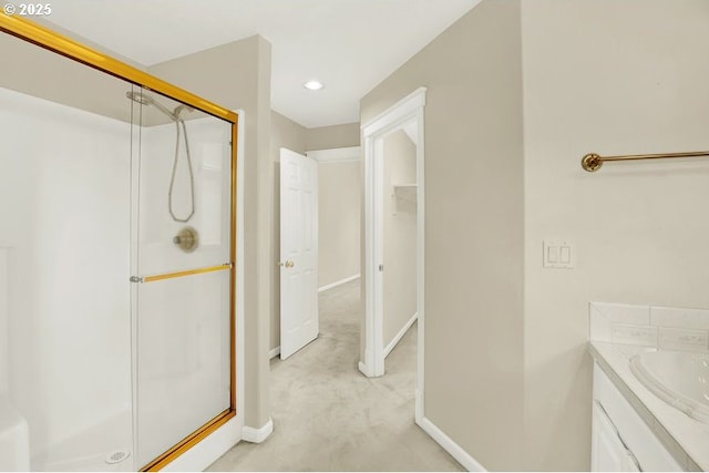 bathroom featuring a shower stall, baseboards, recessed lighting, and vanity
