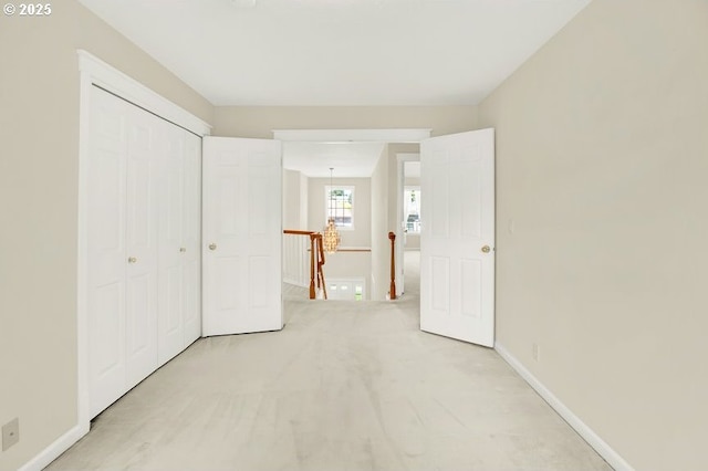 unfurnished bedroom with baseboards, carpet, and a closet