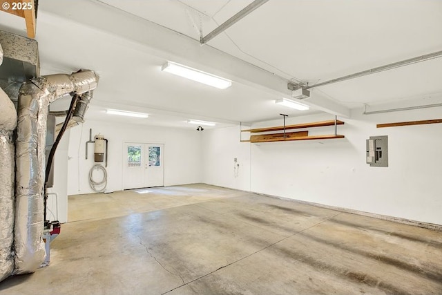 garage featuring electric panel and a garage door opener