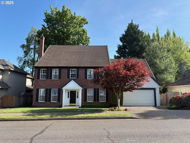 14559 SE Megan Way, Clackamas, OR 97015 - colonial-style house featuring a chimney and a garage
