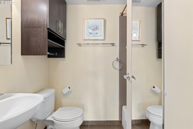 bathroom with sink, toilet, tile patterned flooring, and a shower