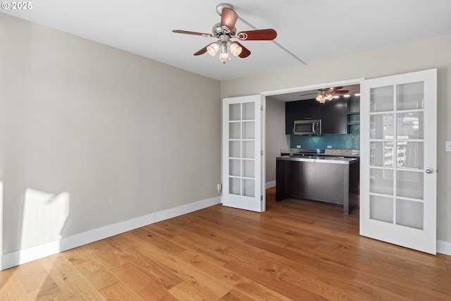 interior space featuring french doors, ceiling fan, and light hardwood / wood-style flooring