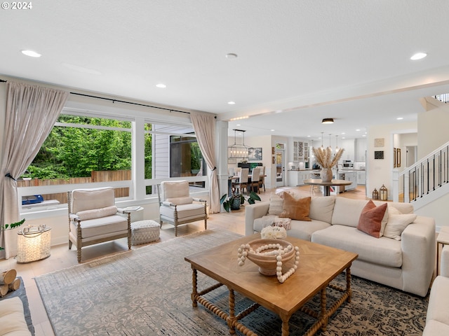 9010 SW Inez St, Tigard, OR 97224 - living area featuring stairway, recessed lighting, wood finished floors, and a chandelier