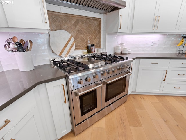 9010 SW Inez St, Tigard, OR 97224 - kitchen featuring range with two ovens, backsplash, white cabinetry, and custom exhaust hood
