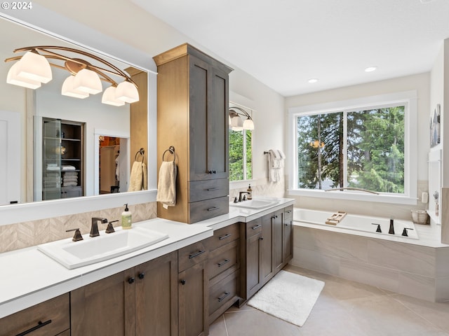 9010 SW Inez St, Tigard, OR 97224 - full bath featuring double vanity, a garden tub, tile patterned flooring, backsplash, and a walk in closet