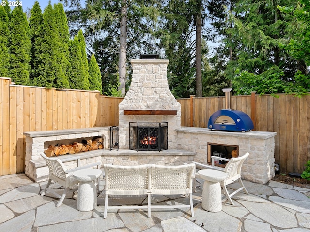 9010 SW Inez St, Tigard, OR 97224 - view of patio / terrace featuring an outdoor stone fireplace and fence